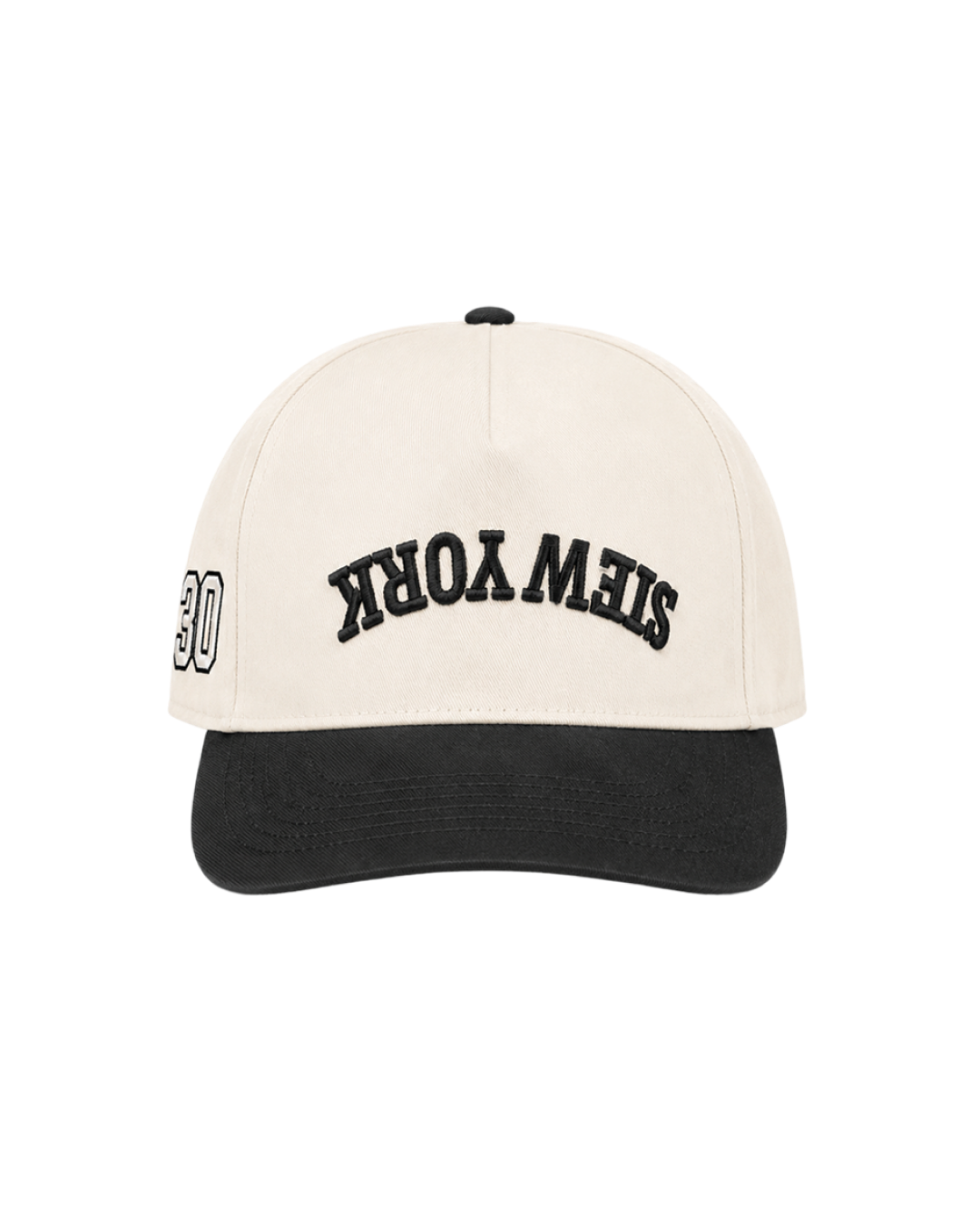A structured baseball cap with an off-white crown and a black curved brim. The crown features black arched embroidery reading 'STEW YORK' and a small black button on top.