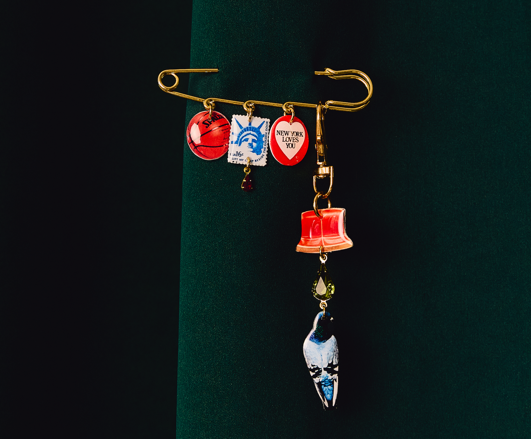 Xl Safety Pin and Charm together on green background