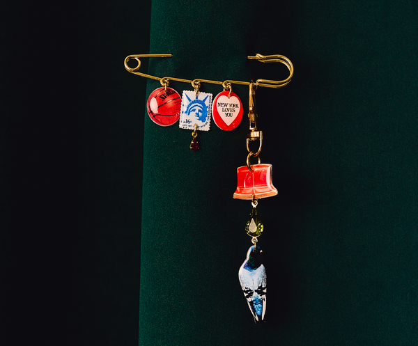 Xl Safety Pin and Charm together on green background