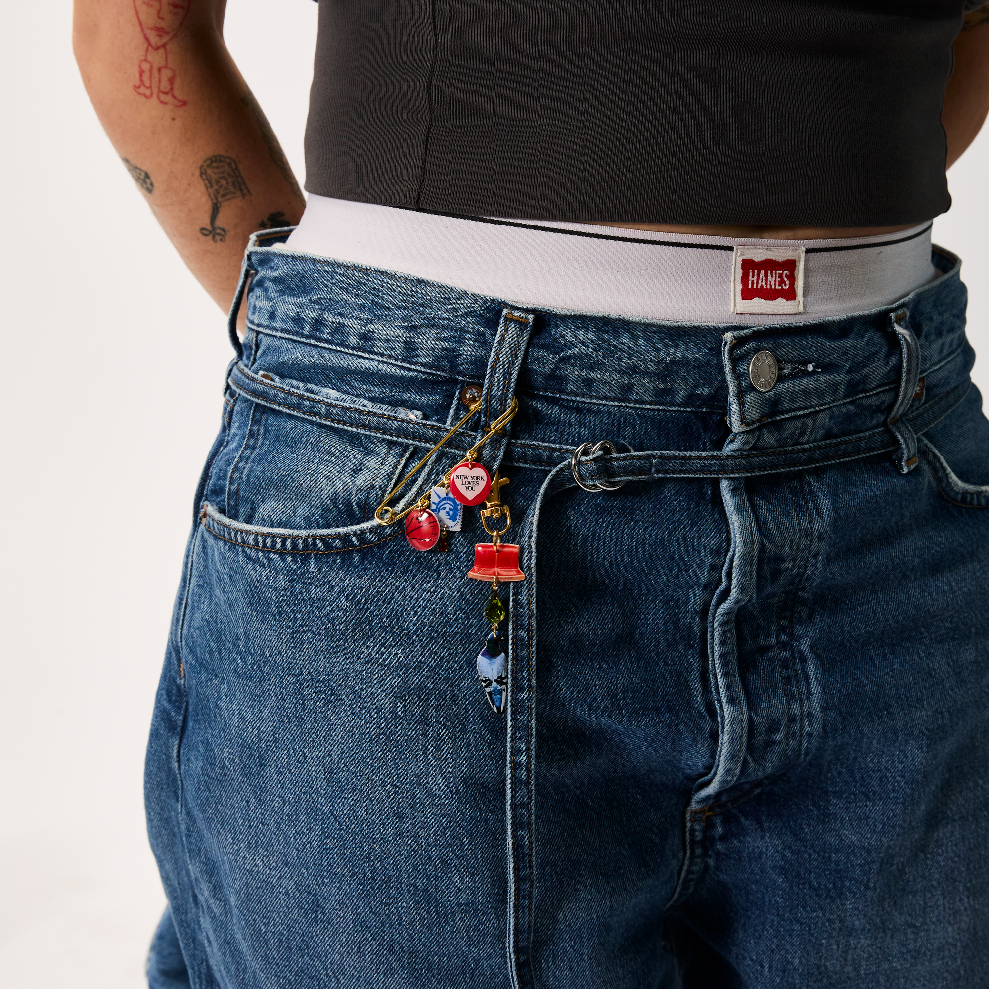 Person wearing blue jeans with XL Safety Pin
