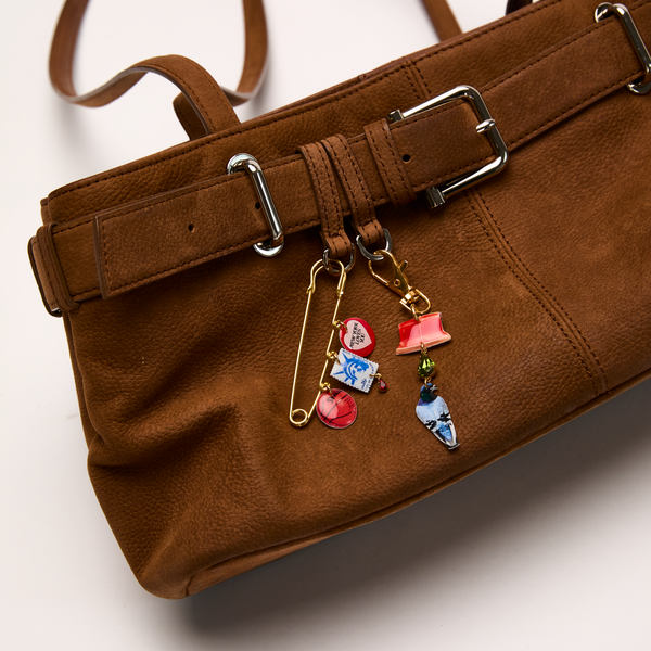 Brown leather handbag styled with XL Safety Pin and City Charm